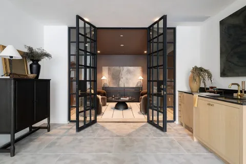 a living room with furniture a chandelier and a flat screen tv