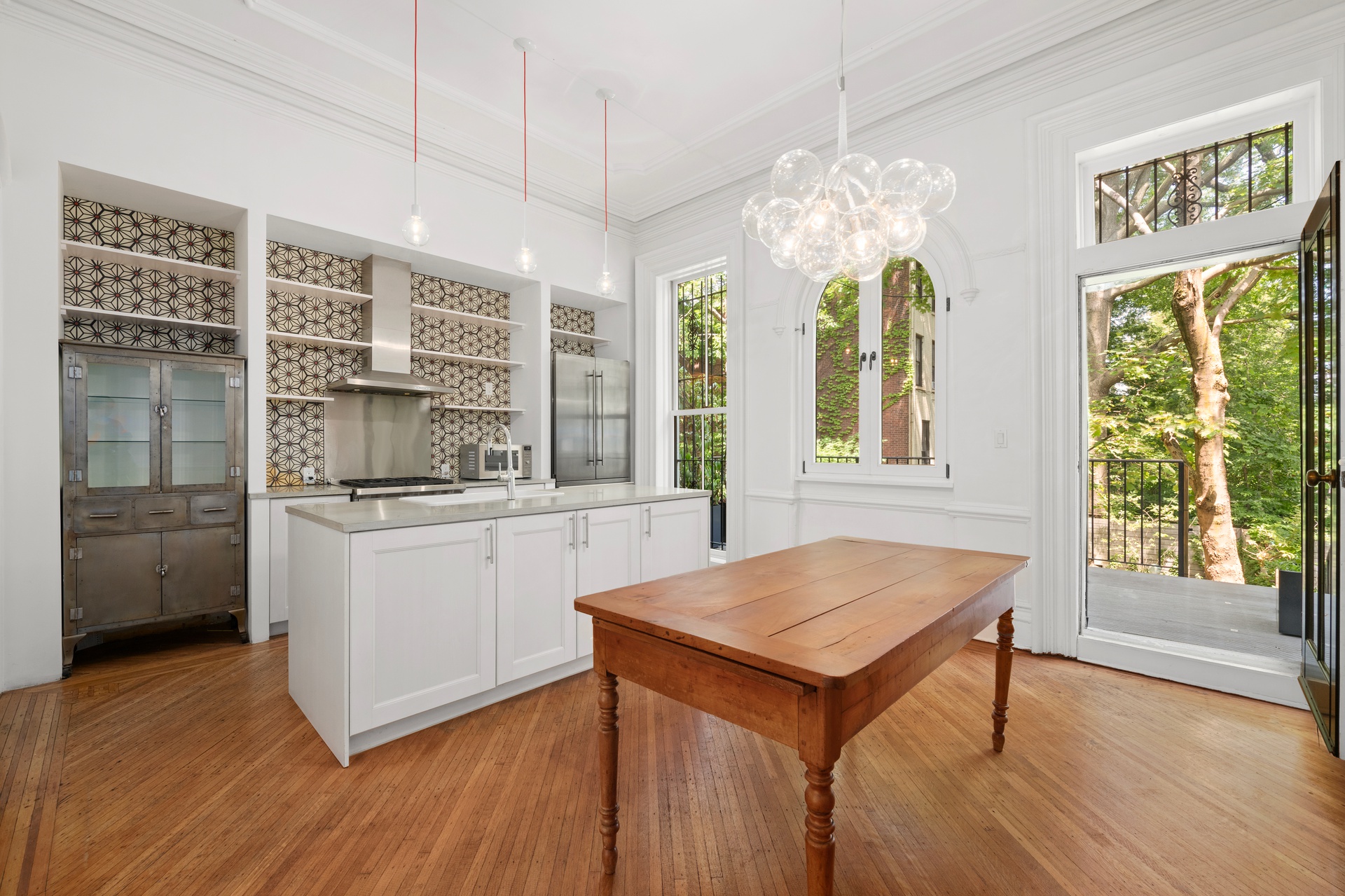 73 St James Place, Unit 2 Brooklyn, NY 11238 - Photo 4 of 15 a kitchen with stainless steel appliances granite countertop a stove top oven a sink dishwasher and white cabinets with wooden floor