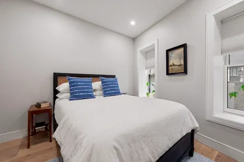 a bedroom with a bed and a window