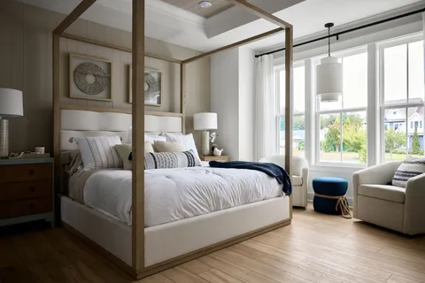 a bedroom with a bed couch and a window