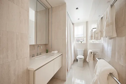 a bathroom with a sink toilet and shower