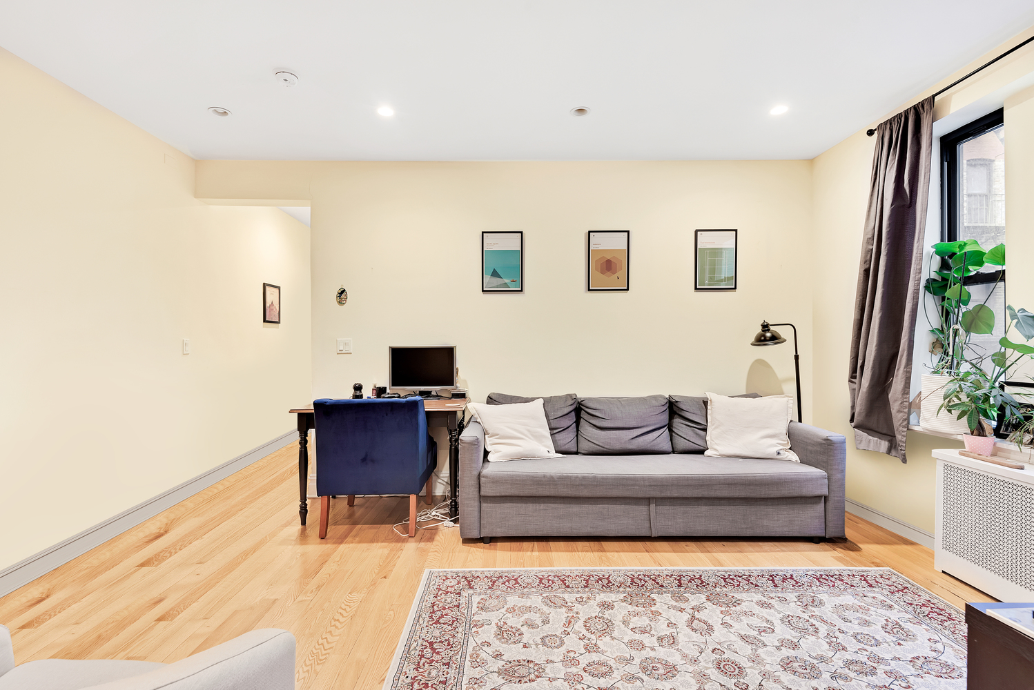 750 Riverside Drive, Unit 3E Manhattan, NY 10031 - Photo 2 of 8 a living room with furniture and a couch