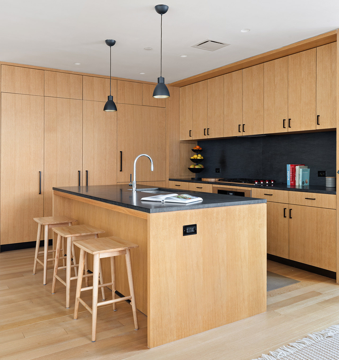 550 West 29th Street, Unit 5A Manhattan, NY 10001 - Photo 3 of 8 a kitchen with stainless steel appliances kitchen island granite countertop a sink a microwave and cabinets