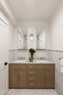 a bathroom with a sink vanity granite and a mirror