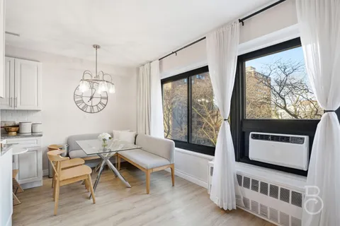 a living room with furniture a window and a table
