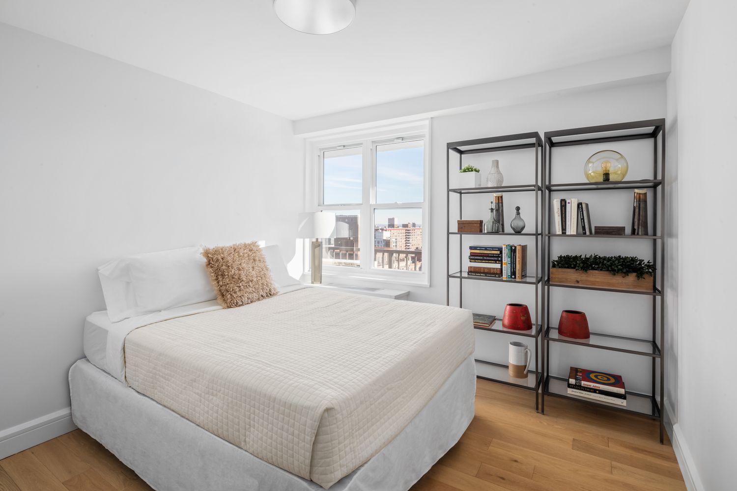 a bedroom with a bed cabinets and window