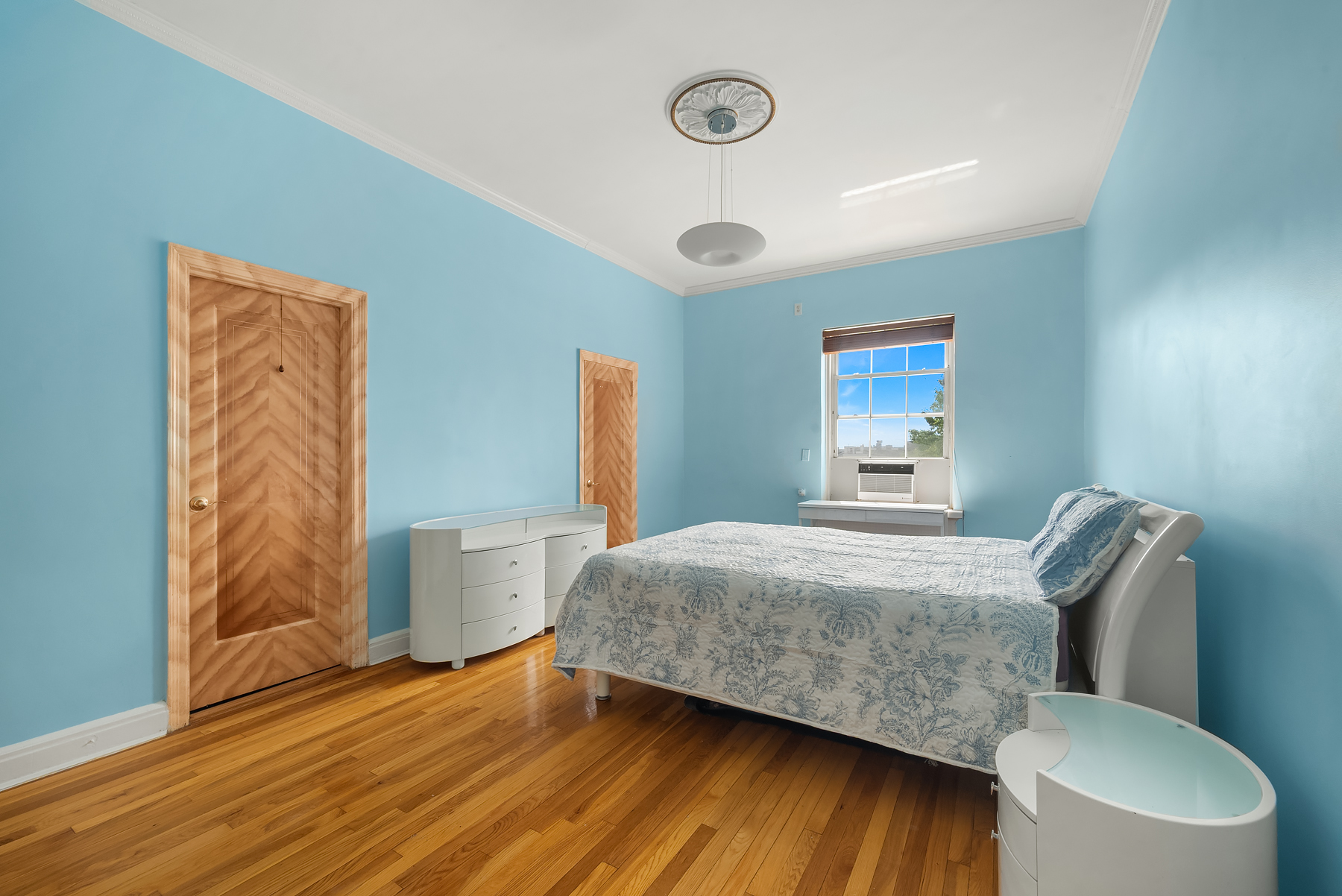 68-10 108th Street, Unit 6D Queens, NY 11375 - Photo 5 of 15 a bedroom with a bed and wooden floor