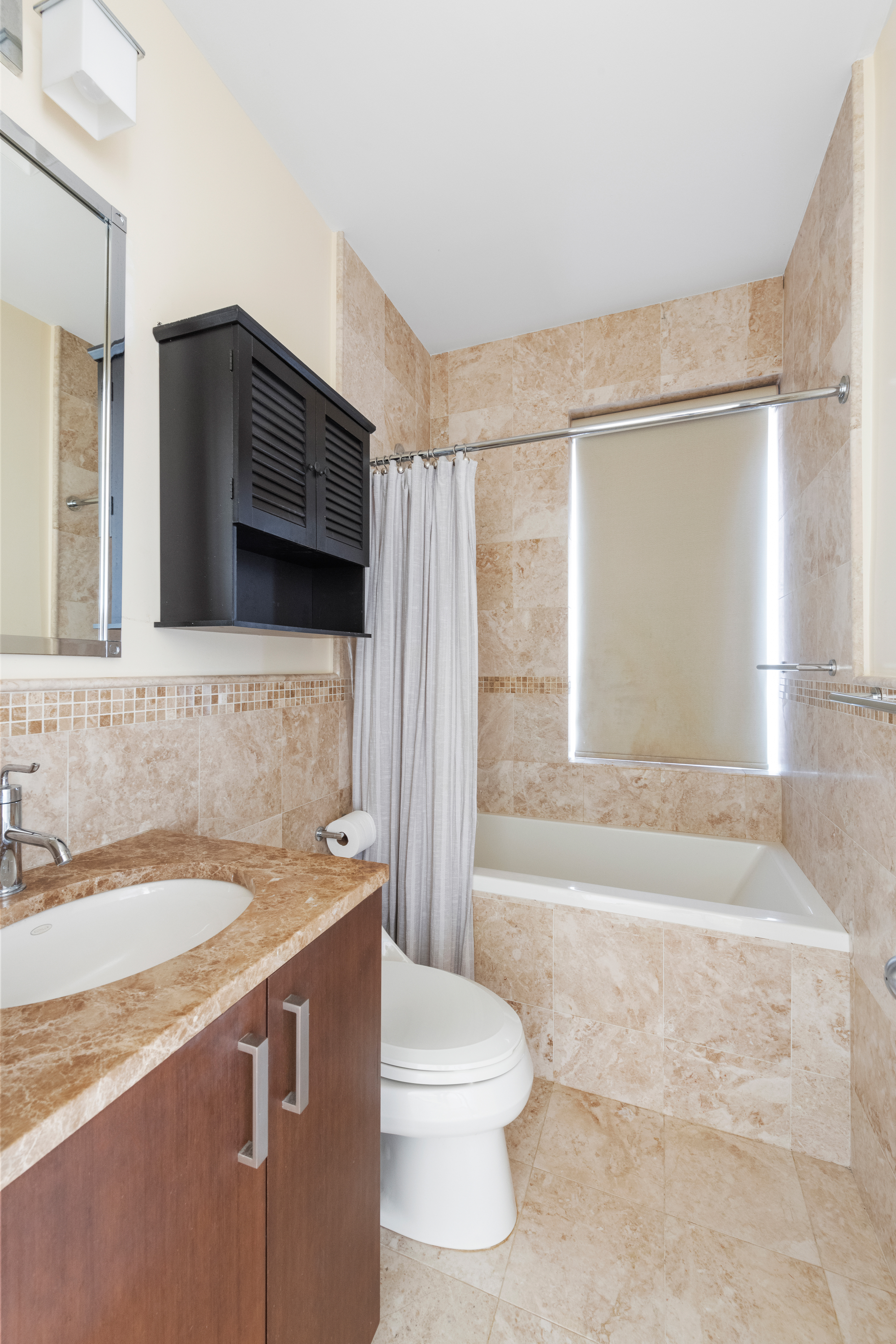 524 East 72nd Street, Unit 24A Manhattan, NY 10021 - Photo 4 of 12 a bathroom with a sink a toilet a mirror and bathtub