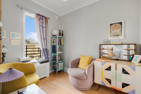 a bedroom with furniture and a wooden floor