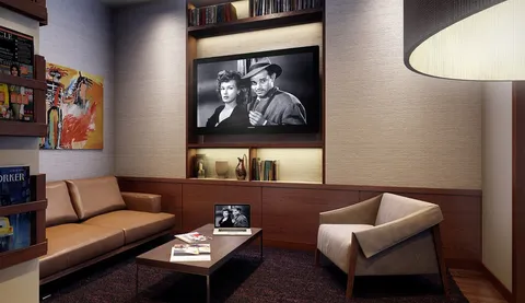 a living room with furniture and a wall painting