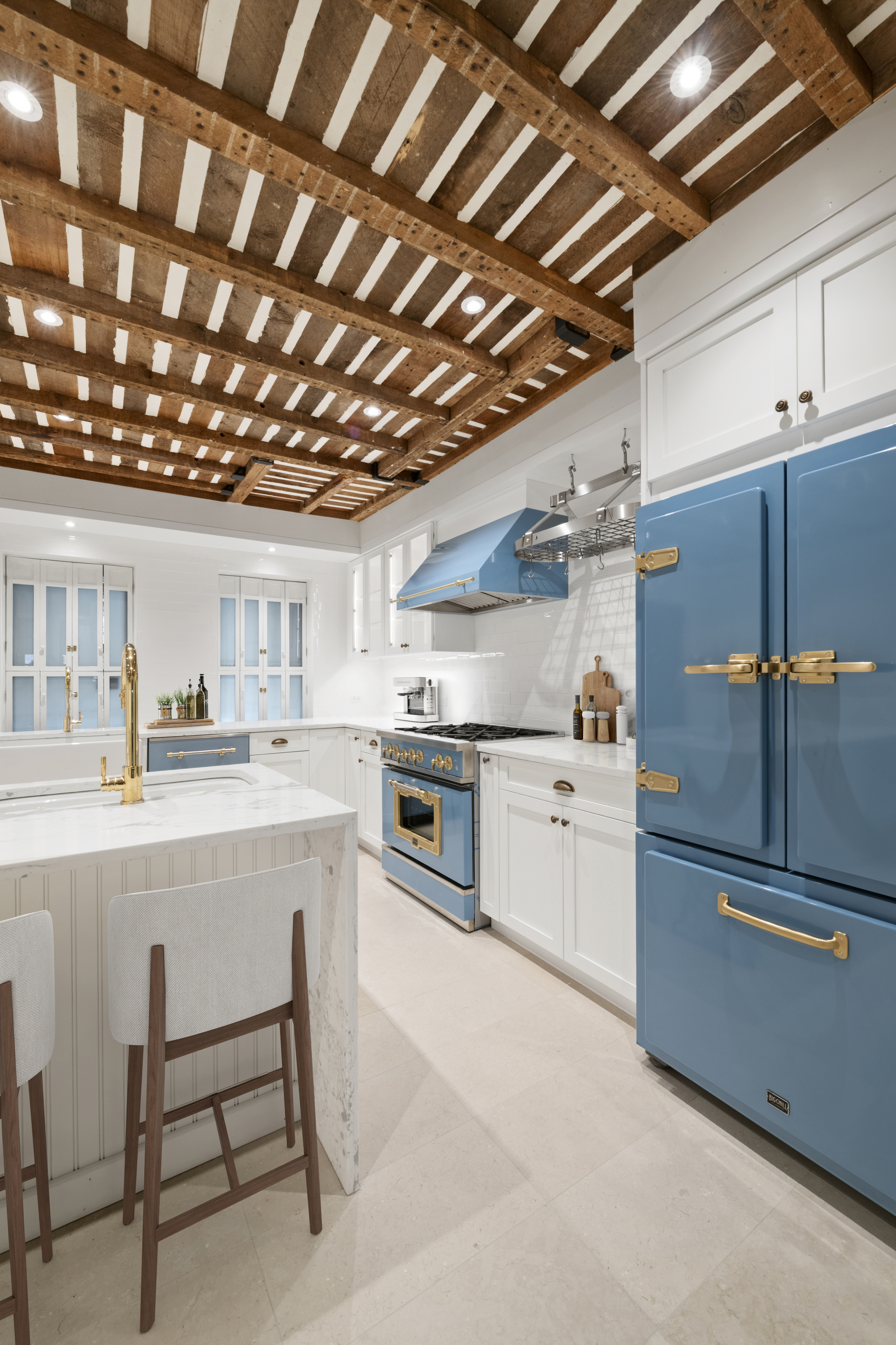 313 West 102nd Street Manhattan, NY 10025 - Photo 19 of 36 a kitchen with cabinets and chairs