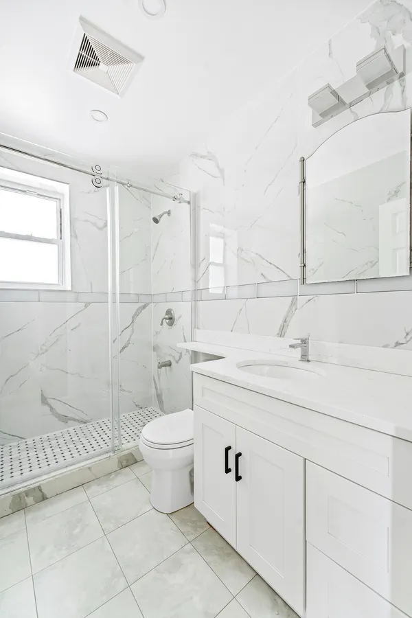 a bathroom with a sink toilet and shower