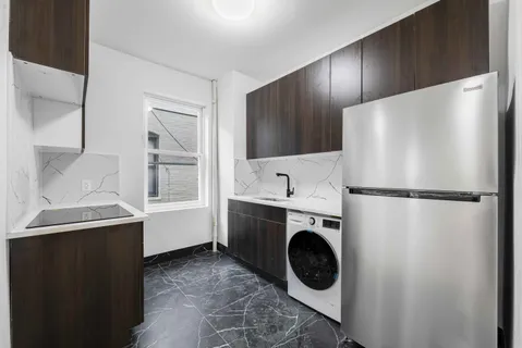 a utility room with sink dryer and washer