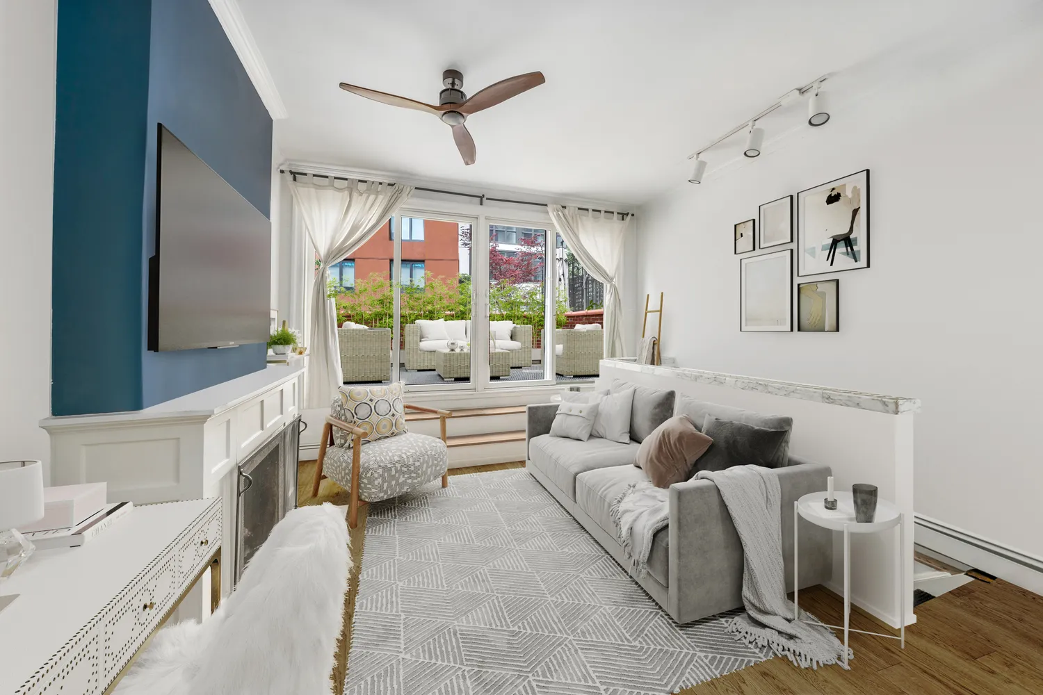 a living room with furniture ceiling fan and a flat screen tv