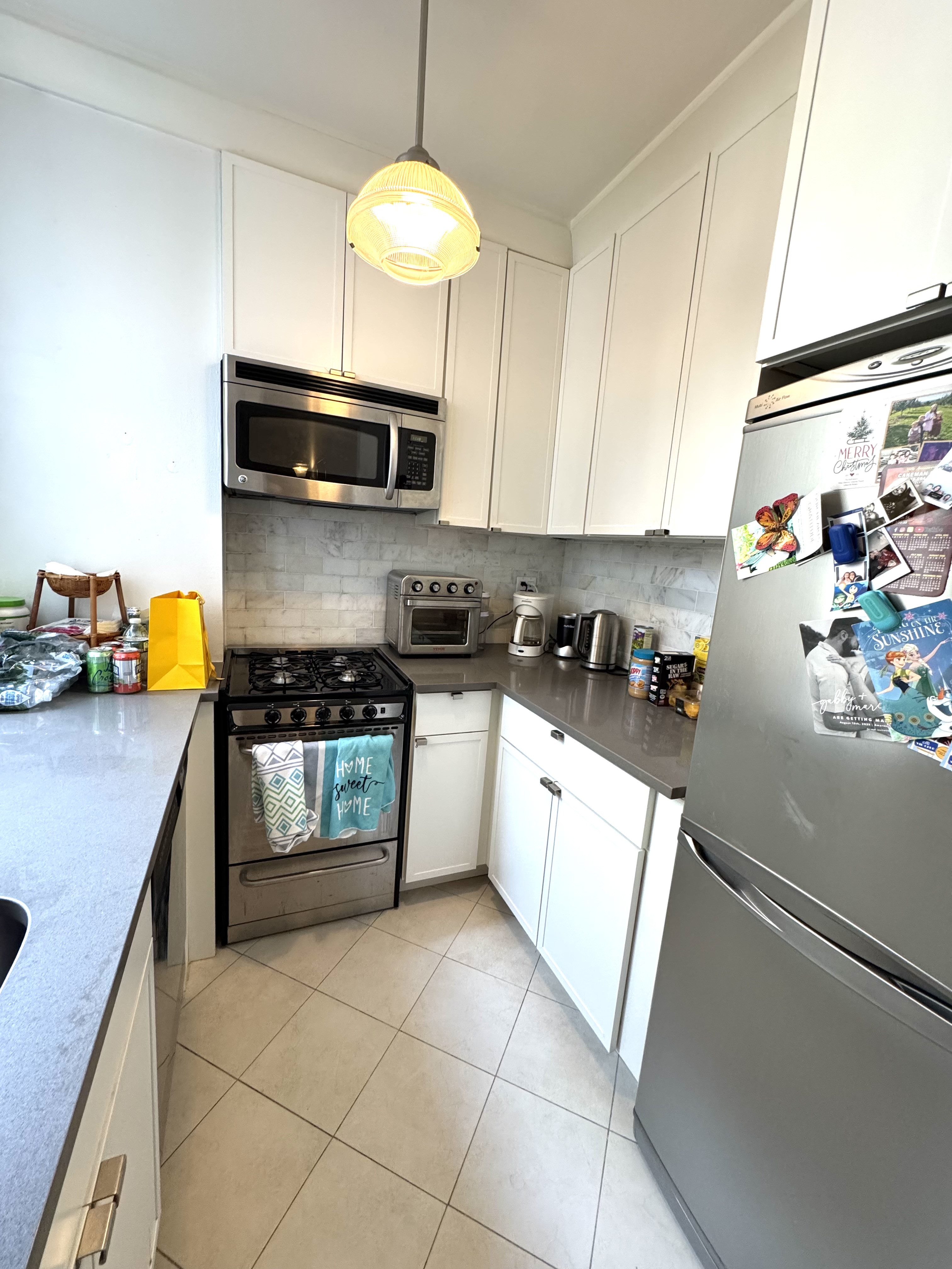 61 East 77th Street, Unit 7E Manhattan, NY 10075 - Photo 7 of 10 a kitchen with stainless steel appliances granite countertop a sink a stove and a refrigerator