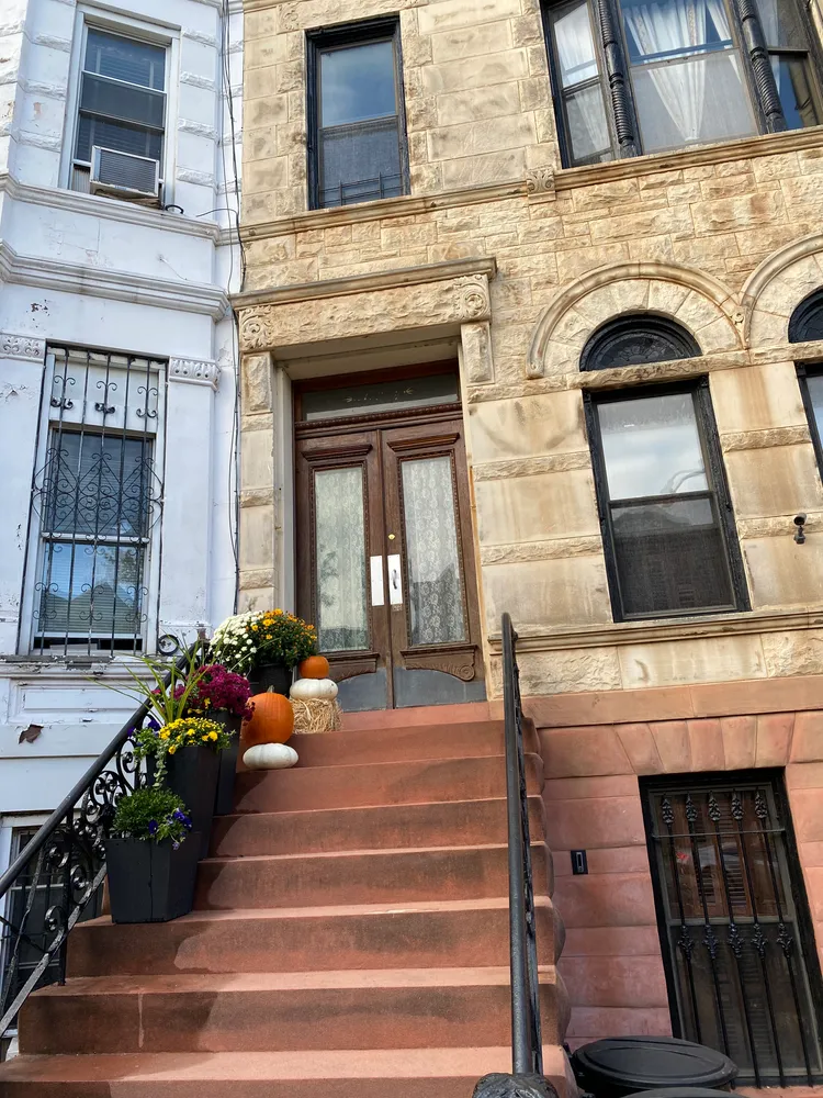 a front view of a house with flower pots