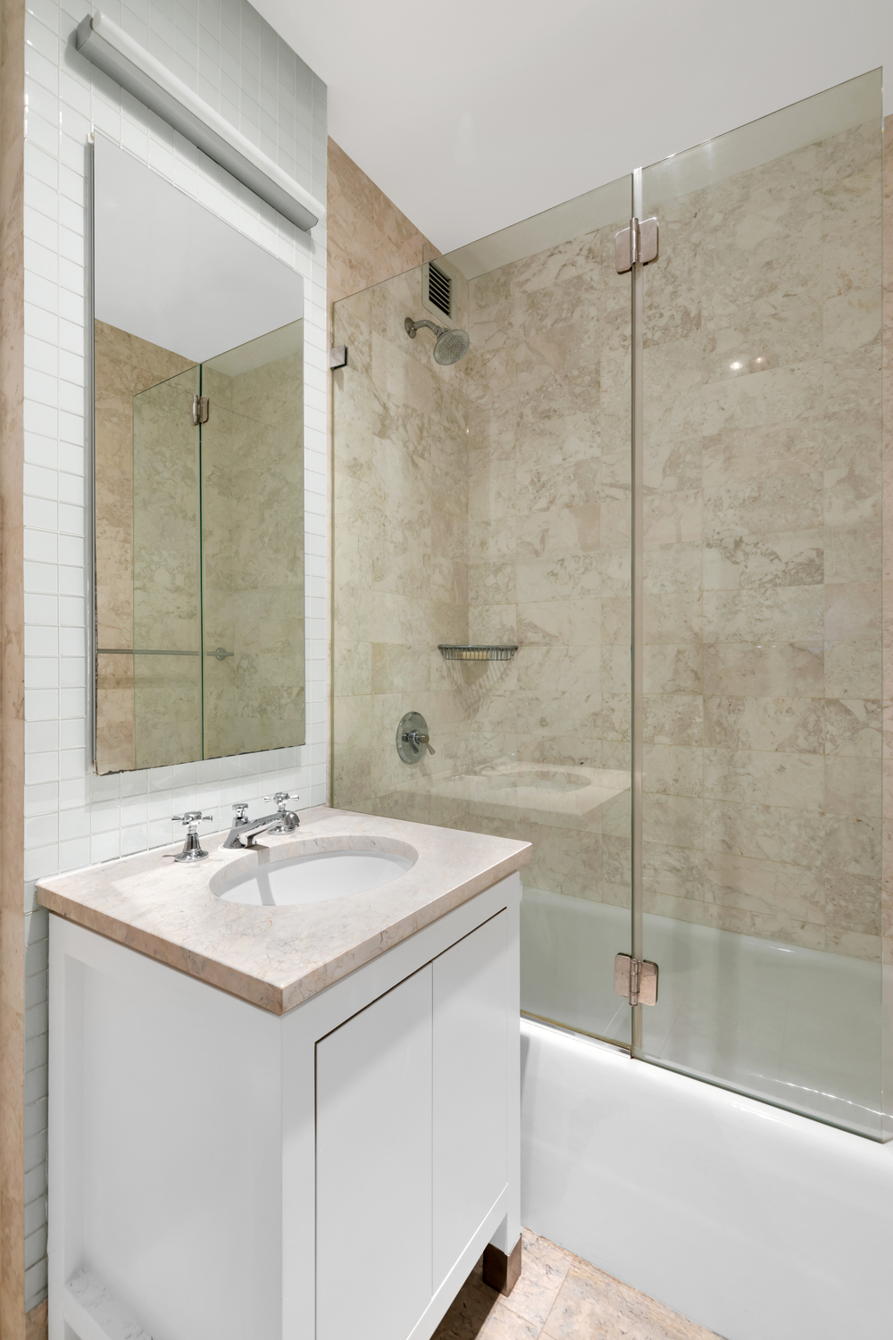 300 East 55th Street, Unit 28B Manhattan, NY 10022 - Photo 7 of 12 a bathroom with a sink and a mirror