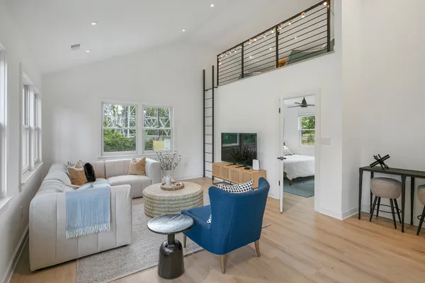 a living room with furniture a fireplace and a large window