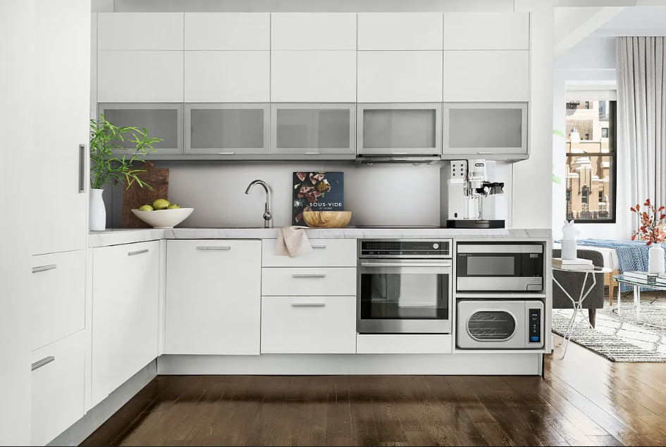 11 East 36th Street, Unit 1203 Manhattan, NY 10016 - Photo 3 of 8 a kitchen with white cabinets and appliances