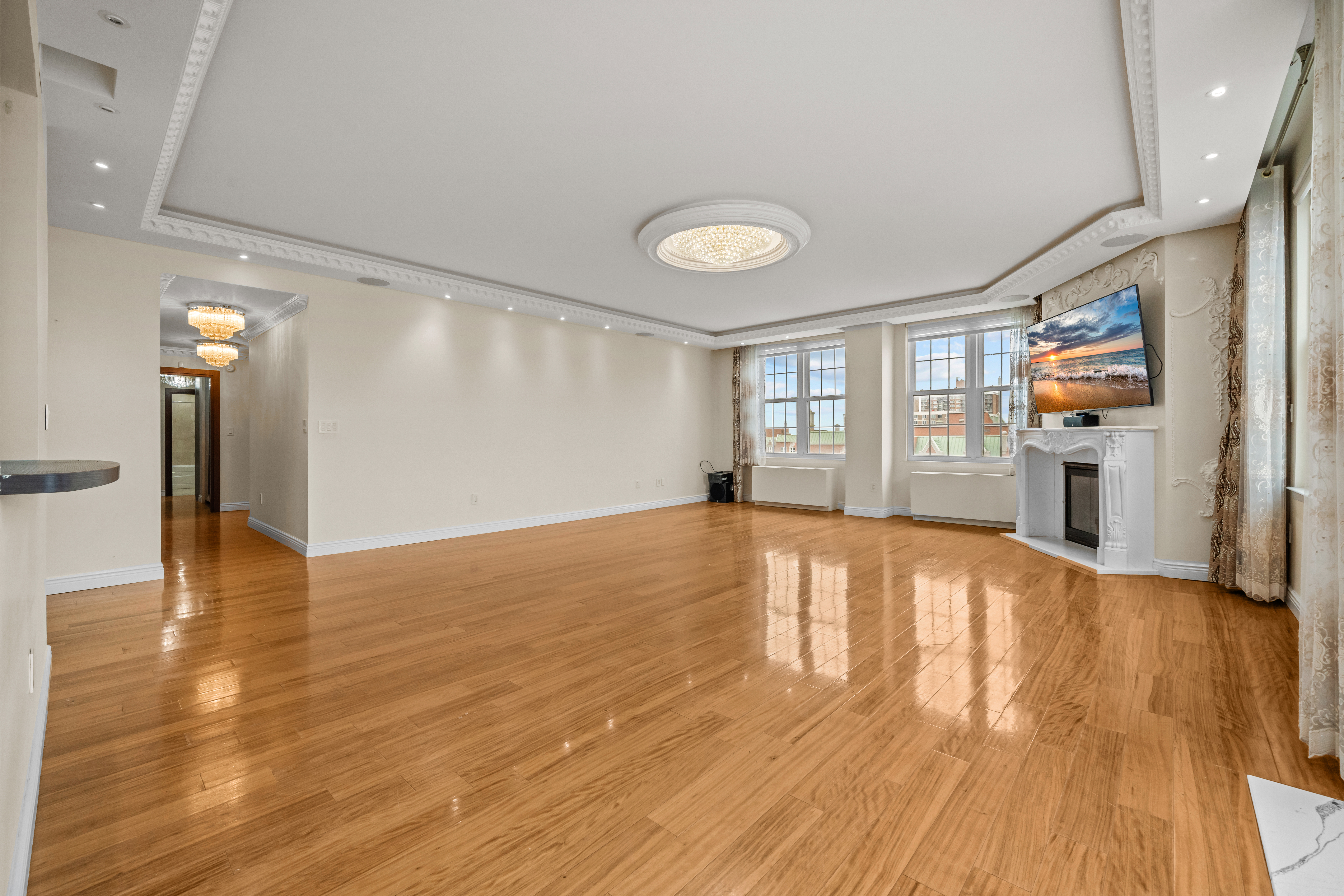 105 Oceana Drive East, Unit PH1D Brooklyn, NY 11235 - Photo 5 of 27 a view of empty room with wooden floor and fan