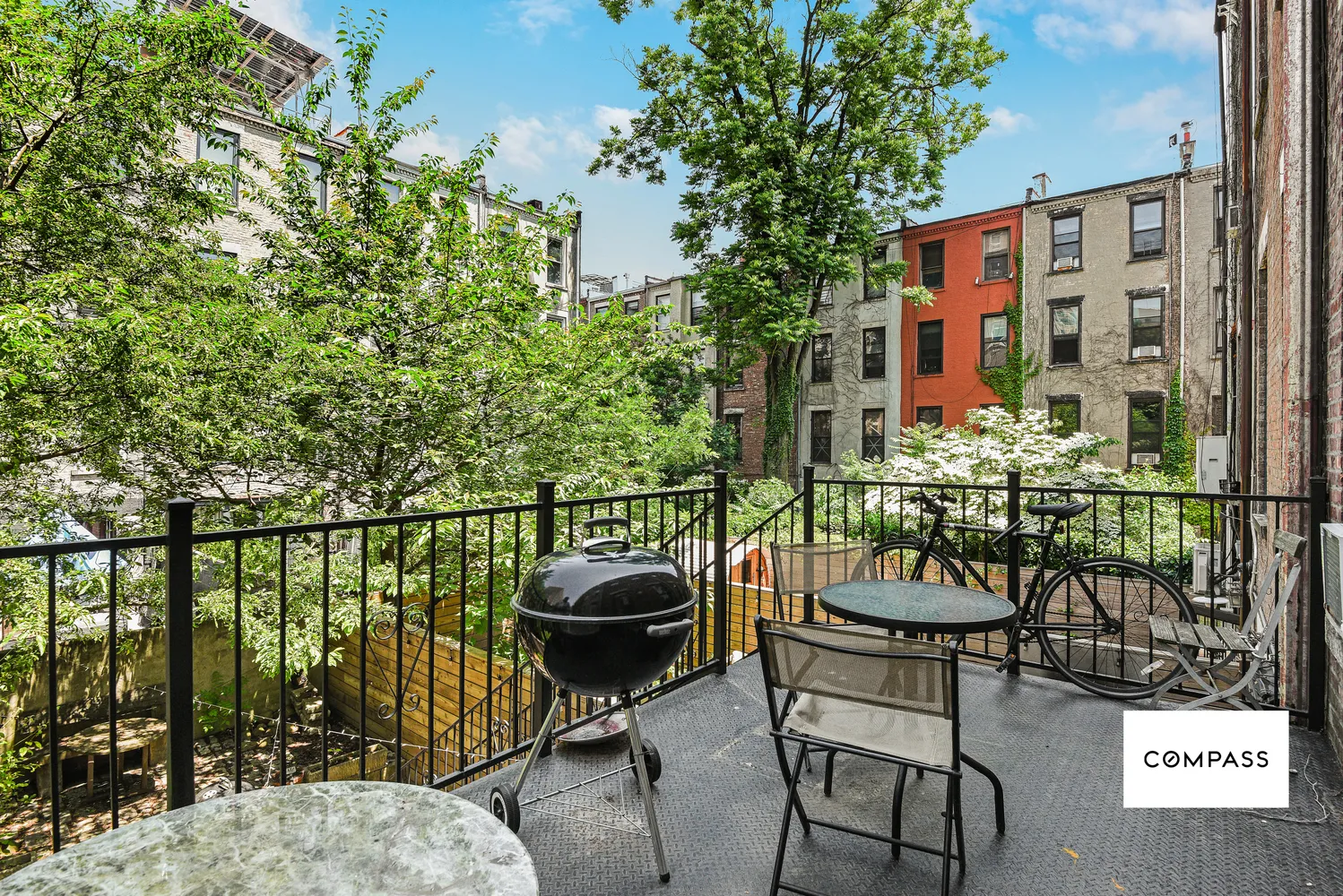 a balcony with chairs and with potted plants