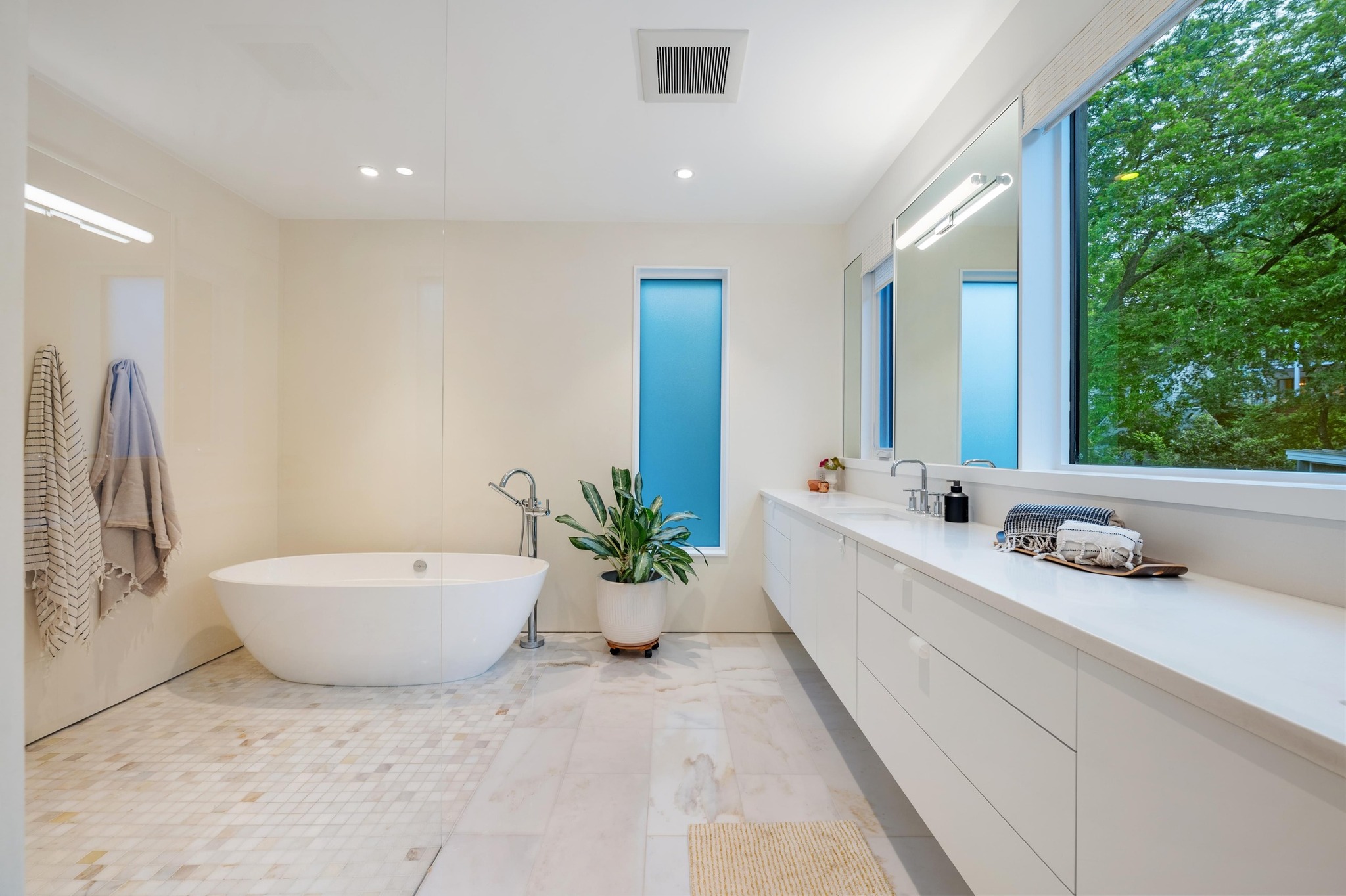 1206 Bickler Road Austin, TX 78704 - Photo 41 of 65 a spacious bathroom with a double vanity sink and a bathtub
