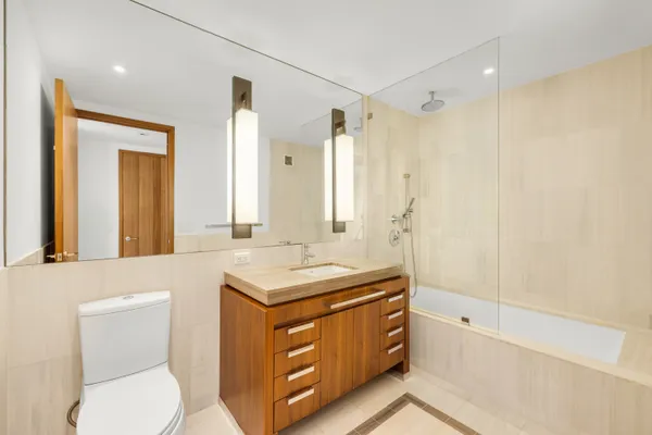 a bathroom with a toilet sink and mirror