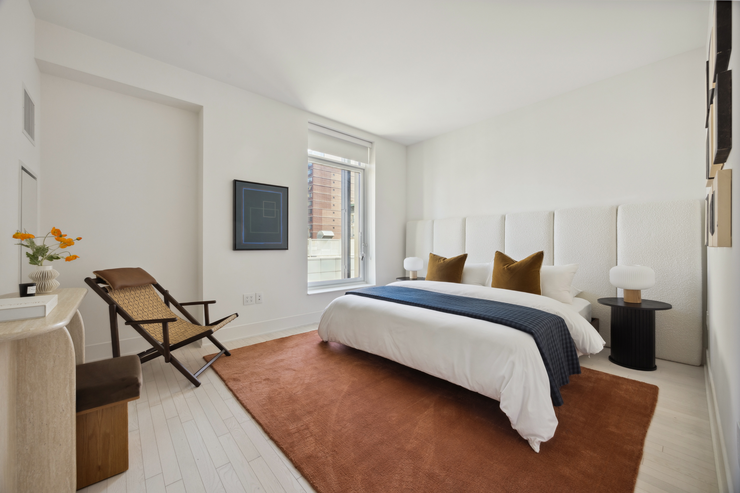 91 Leonard Street, Unit 11G Manhattan, NY 10013 - Photo 6 of 16 a bedroom with a bed and a chair