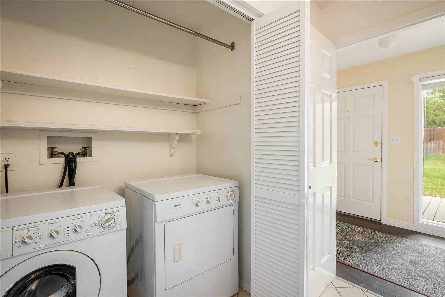 a view of storage and utility room with washer and dryer