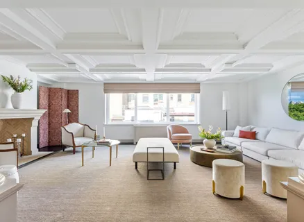 a living room with furniture and a floor to ceiling window or shelf