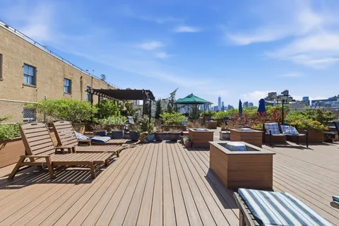 a view of a balcony with chairs and wooden floor