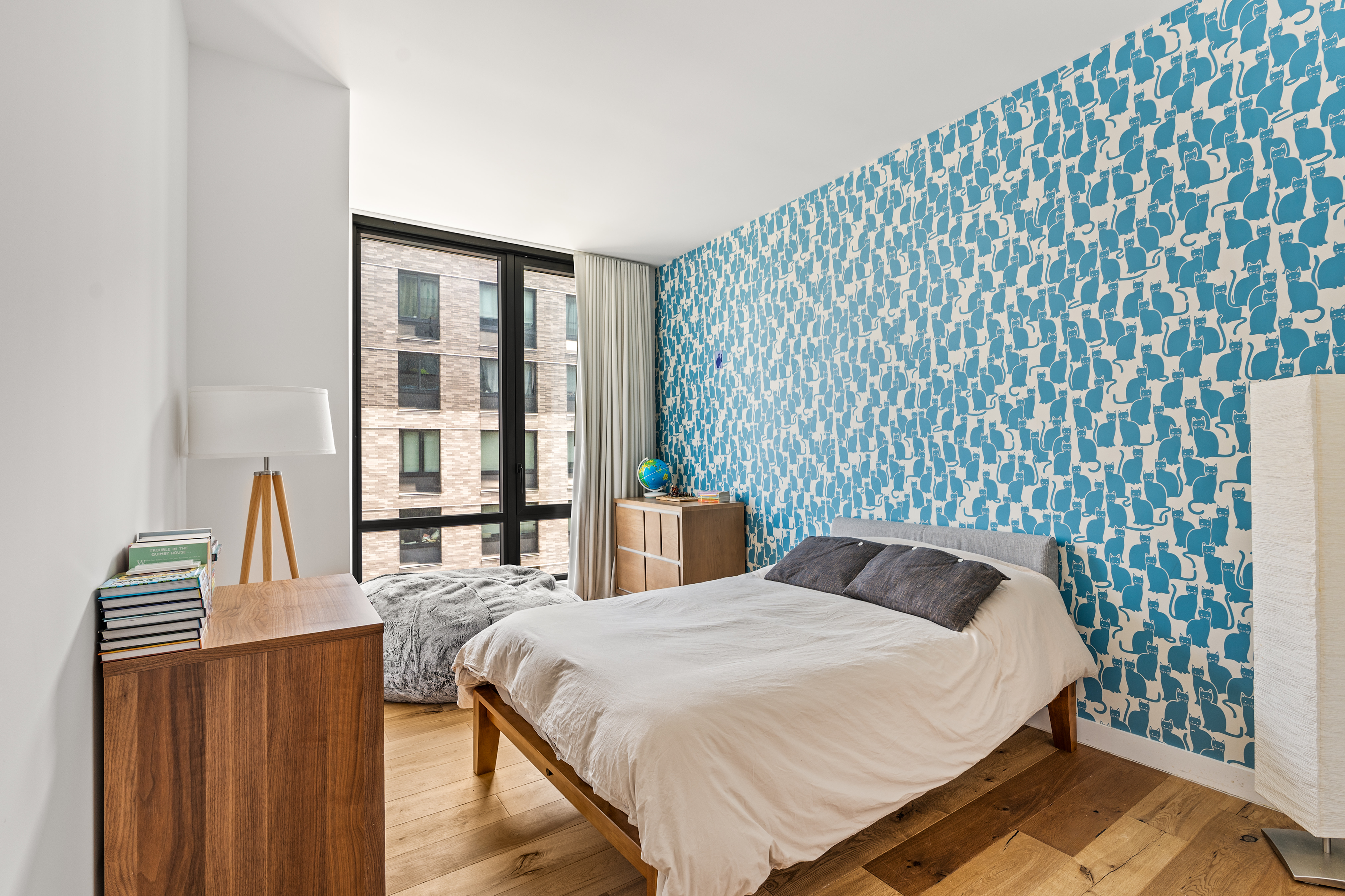 23 West 116th Street, Unit 7A Manhattan, NY 10026 - Photo 6 of 14 a bedroom with a bed and wooden floor