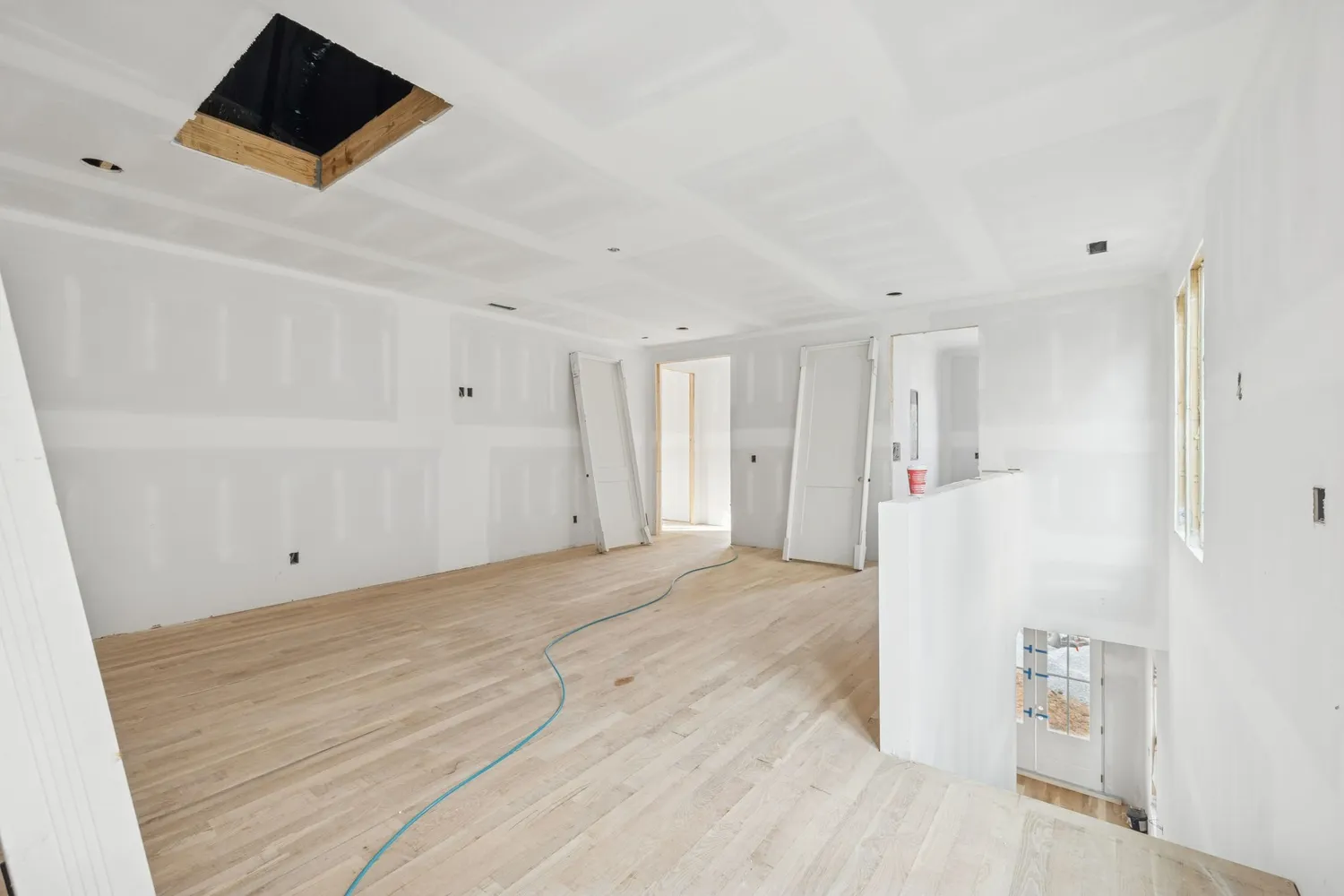 a view of a room with wooden floor and a bathroom