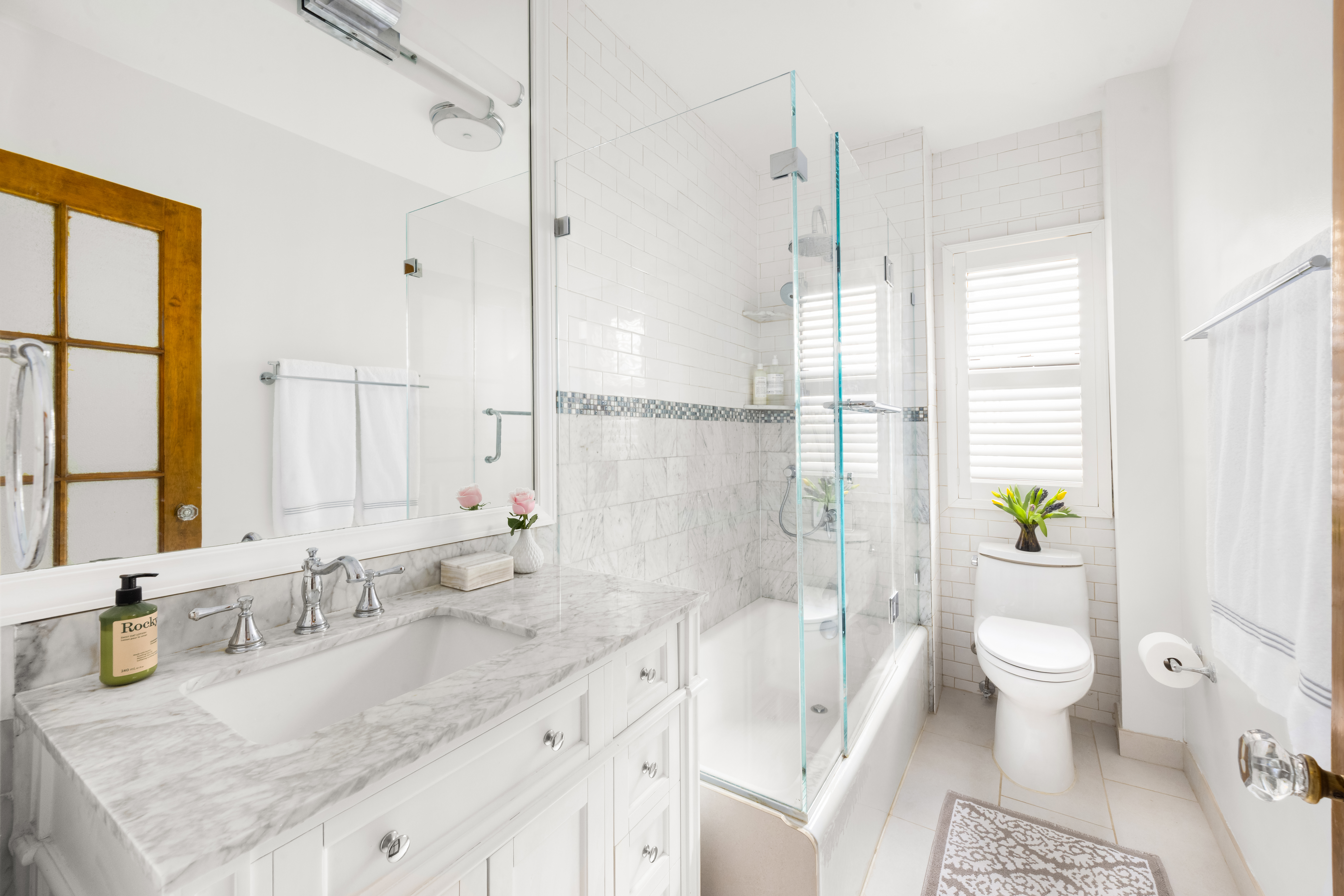 119 West 71st Street, Unit 9B Manhattan, NY 10023 - Photo 11 of 18 a bathroom with a granite countertop sink a toilet a large mirror and shower