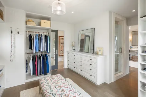 a view of a bedroom with furniture and closet