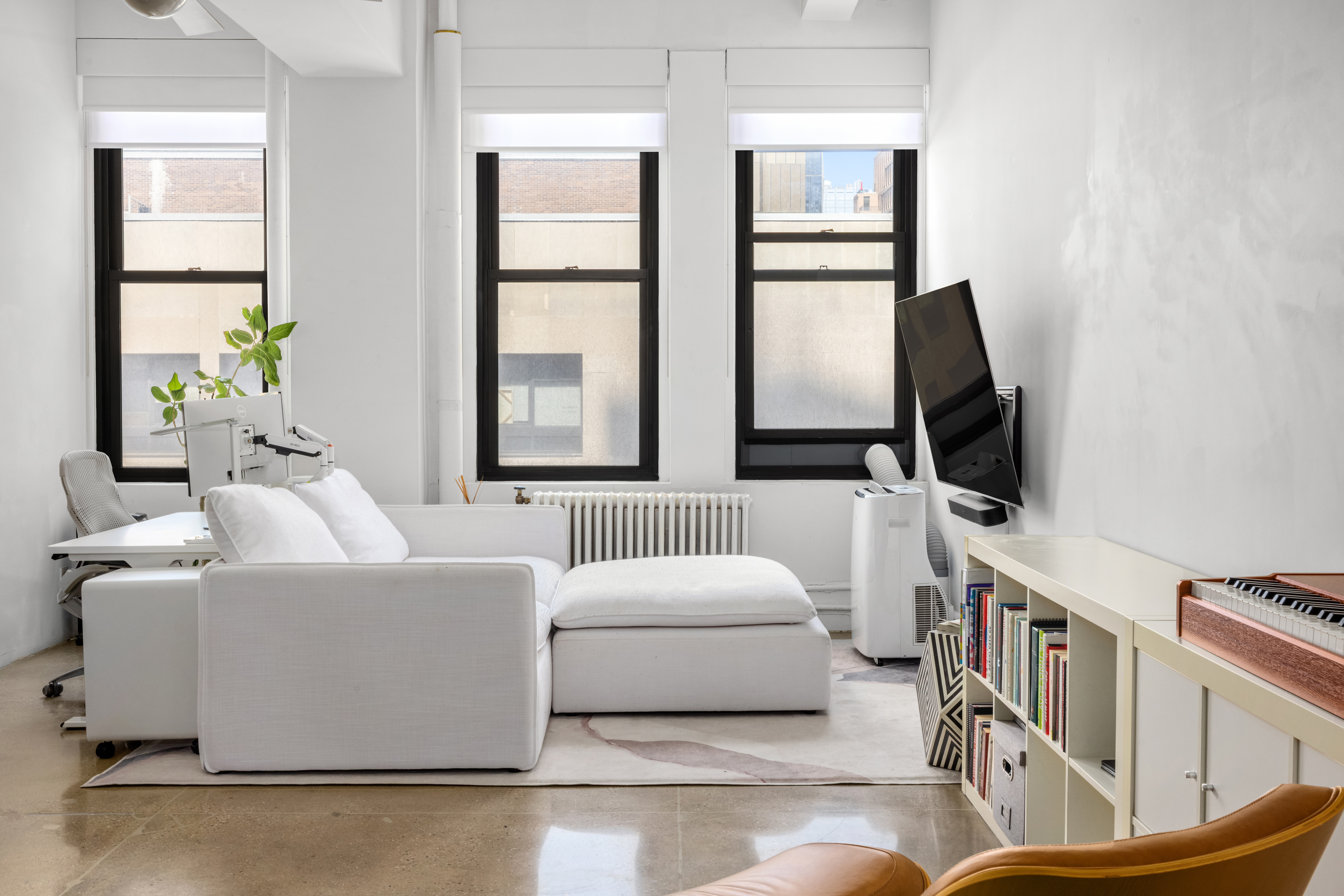 315 7th Avenue, Unit 6C Manhattan, NY 10001 - Photo 3 of 10 a living room with furniture and a flat screen tv