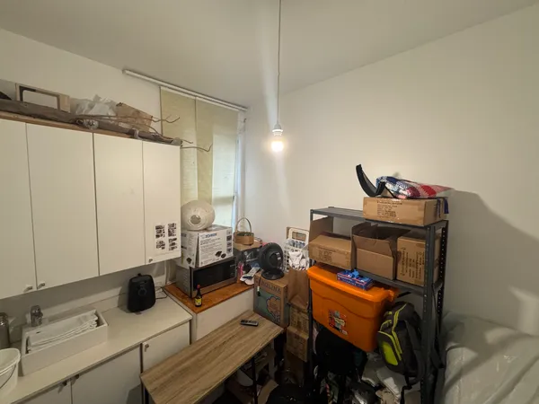 a bedroom with furniture and a mirror