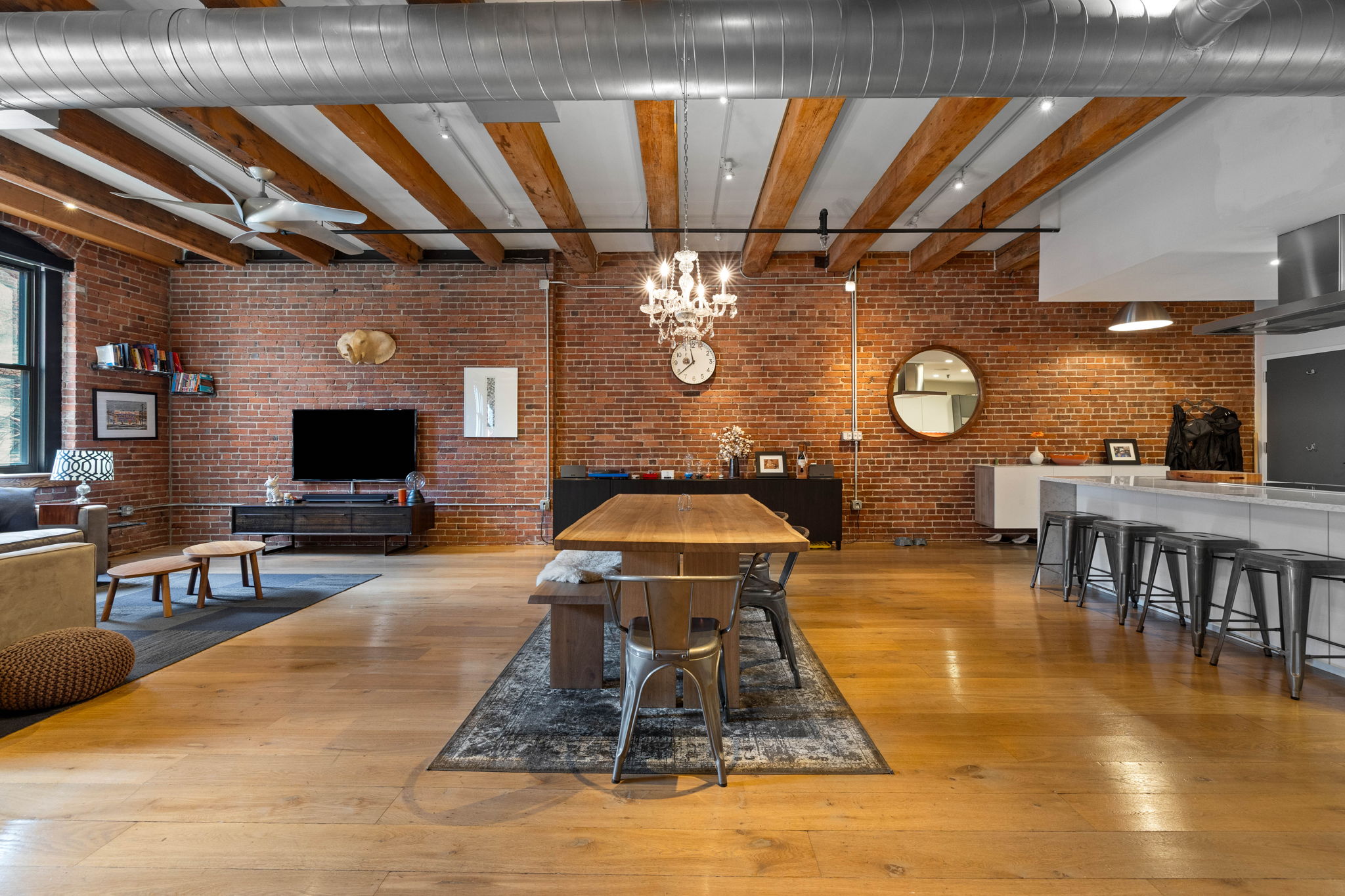 33 Sleeper Street, Unit 307 Boston, MA 02210 - Photo 11 of 15 a living room with a couch a dining table and chairs