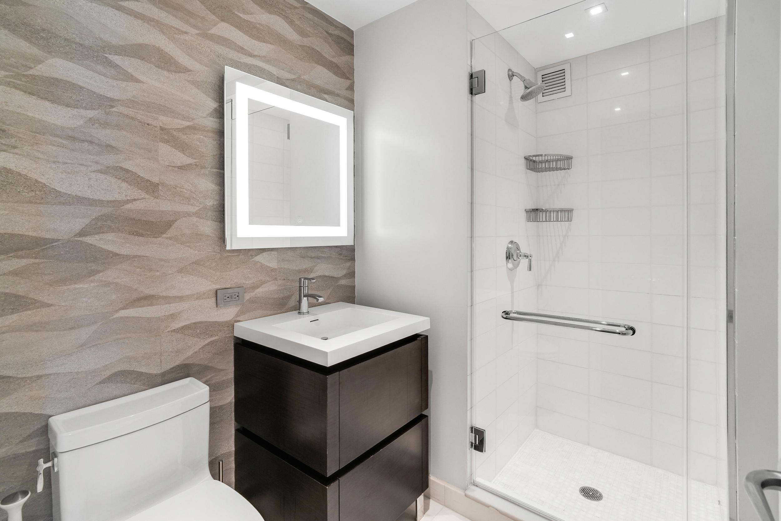 205 East 85th Street, Unit 16H Manhattan, NY 10028 - Photo 5 of 14 a bathroom with a sink toilet and shower