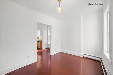 an empty room with wooden floor and closet