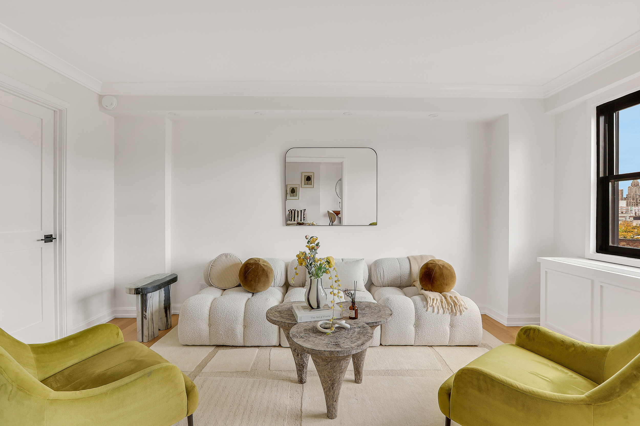 31 Jane Street, Unit 10FG Manhattan, NY 10014 - Photo 3 of 27 a living room with furniture and a large window