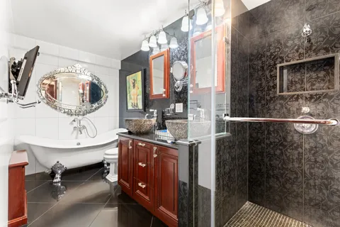 a view of a bedroom with a window and bathroom