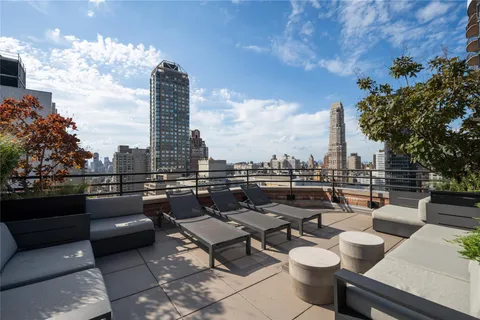 a terrace with outdoor seating city view and barbeque oven