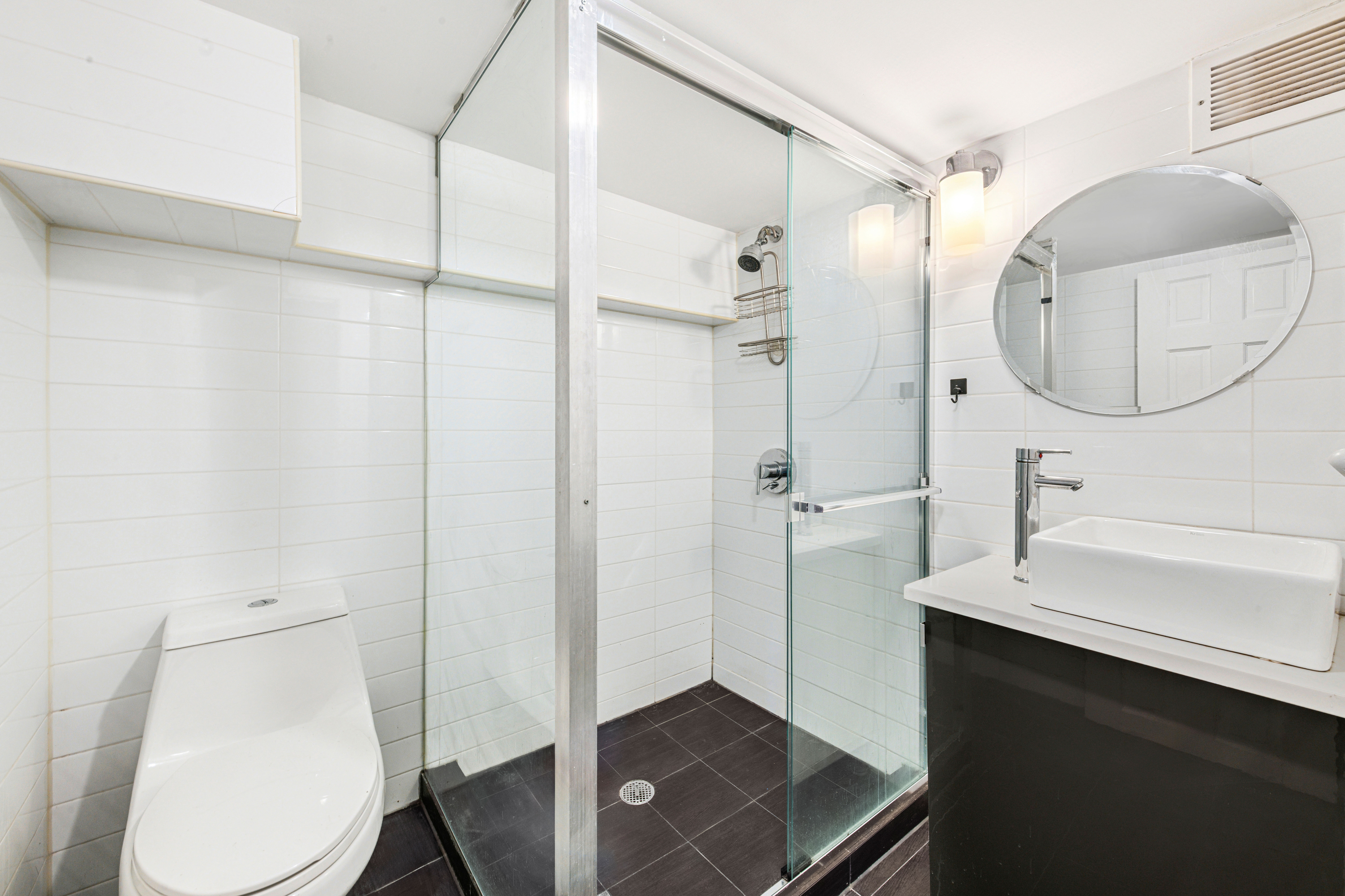 155 A 9th Street, Unit 1 Brooklyn, NY 11231 - Photo 13 of 15 a bathroom with a sink a toilet and a mirror