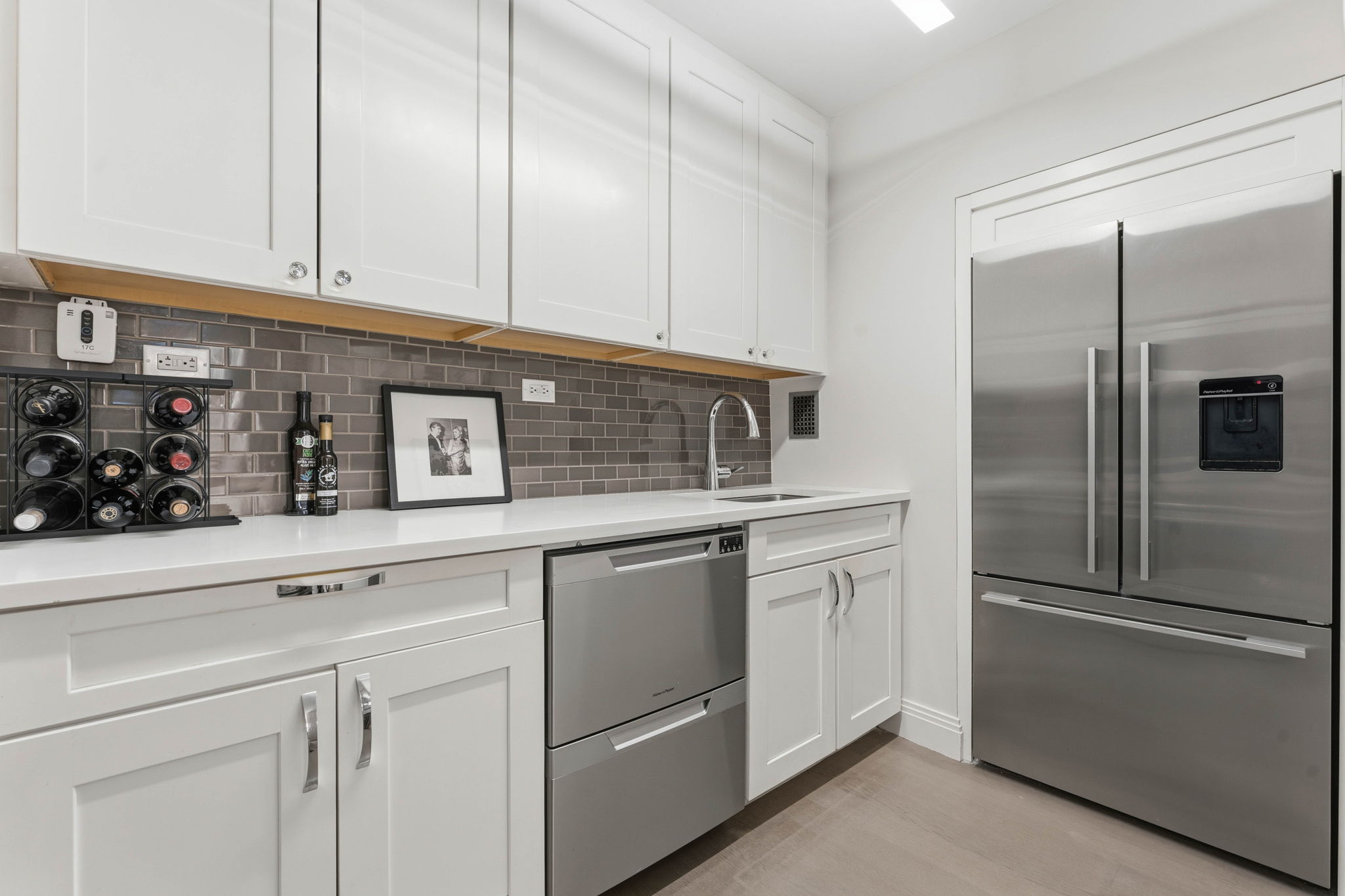 245 East 87th Street, Unit 17C Manhattan, NY 10128 - Photo 6 of 11 a kitchen with stainless steel appliances granite countertop a refrigerator and a sink