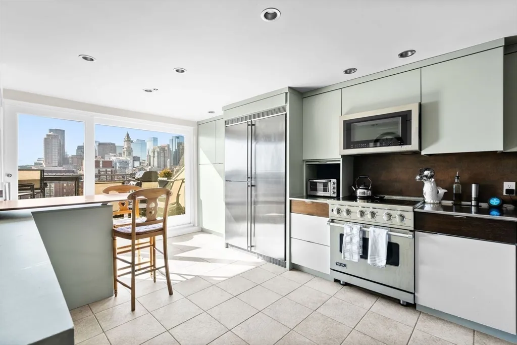 a kitchen with stainless steel appliances granite countertop a stove a sink and a refrigerator