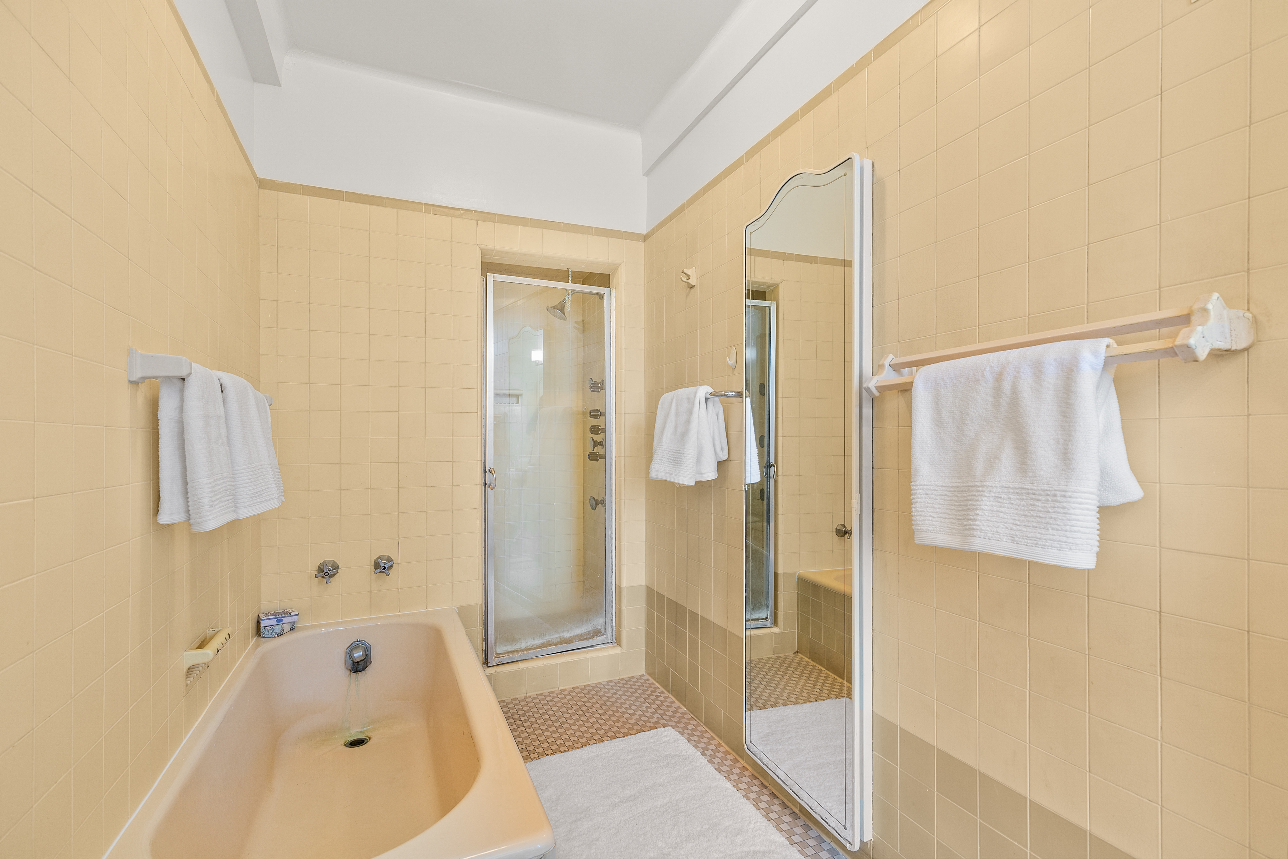 115 Central Park West, Unit 16H Manhattan, NY 10023 - Photo 17 of 30 a bathroom with a bathtub and a shower