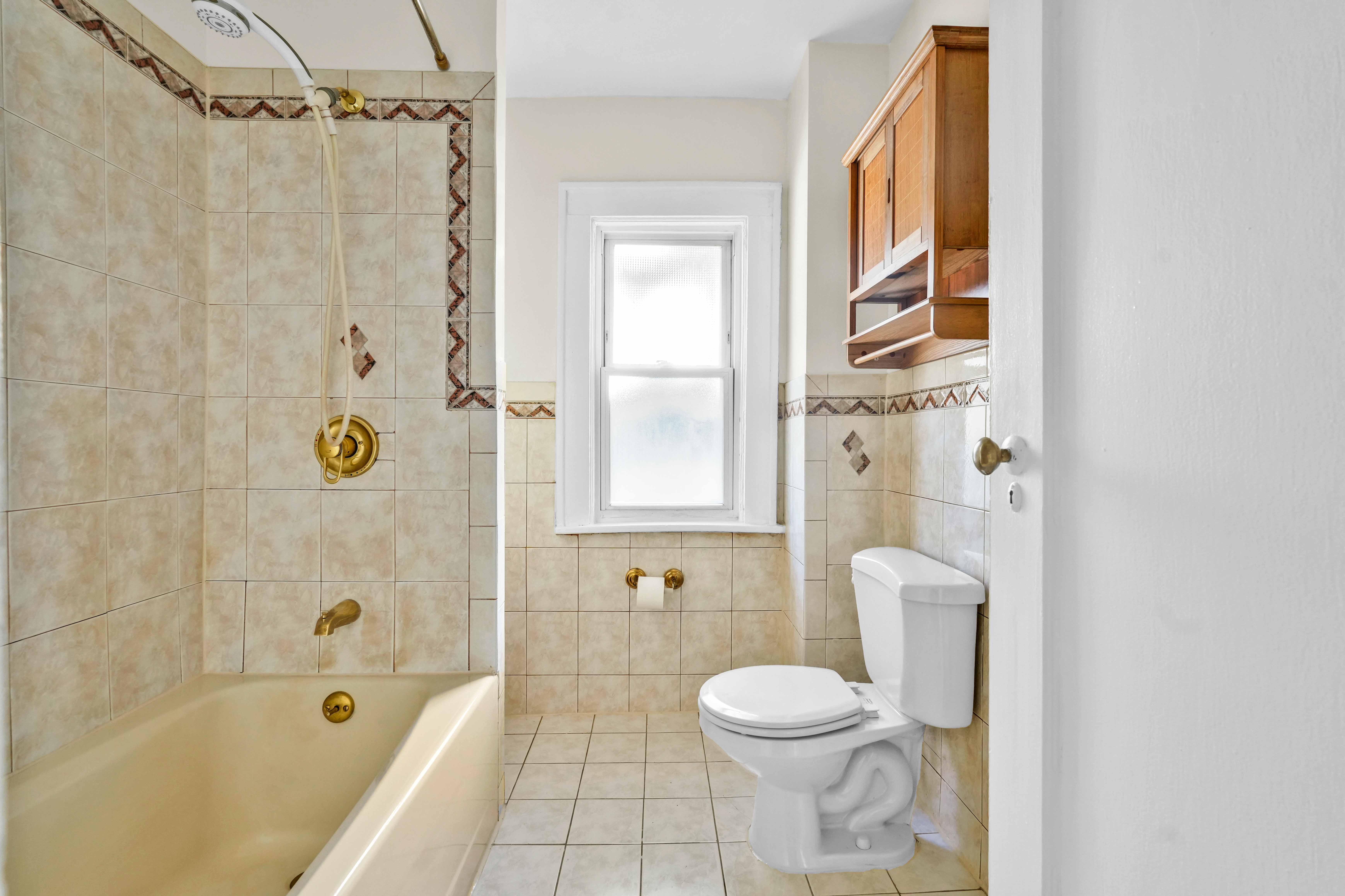 642 East 26th Street Brooklyn, NY 11210 - Photo 19 of 32 a bathroom with a toilet and shower