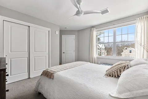 a bedroom with a large bed and a window