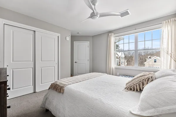 a bedroom with a large bed and a window